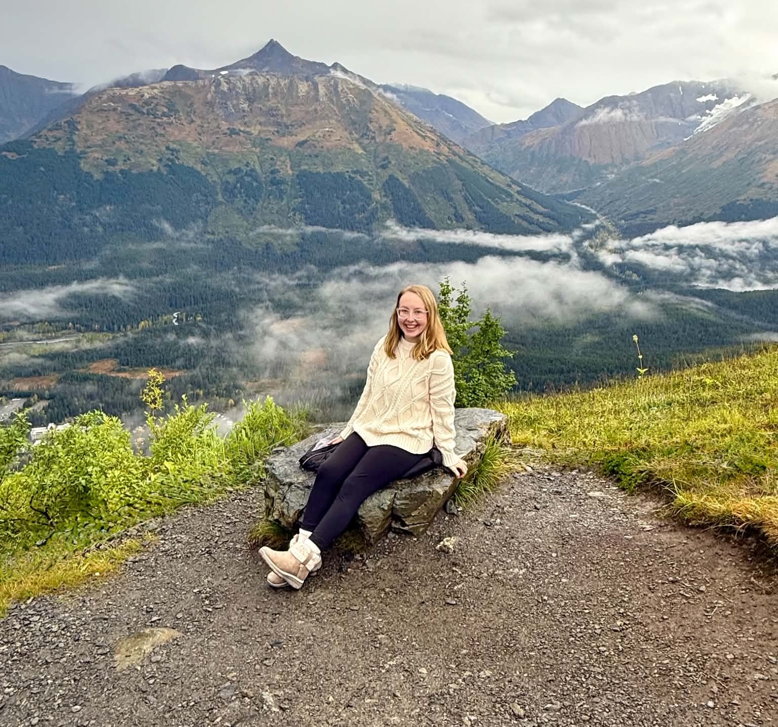 Kayla Smith, travel advisor against backdrop of Alaskan mountains