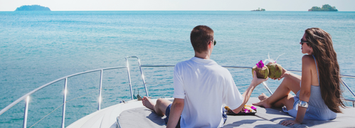 Couple enjoying a romantic dinner on a boat at sunset