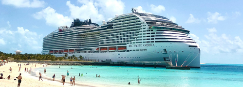 Cruise ship in turquoise waters from beach